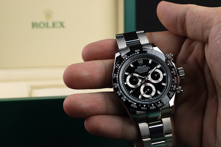 Man Holding a Rolex Cosmograph