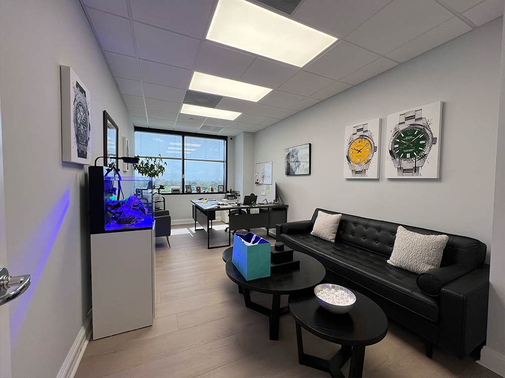 Modern private office at WPB Watch Co, featuring luxury watch art and a welcoming setting for one-on-one watch consultations in West Palm Beach.