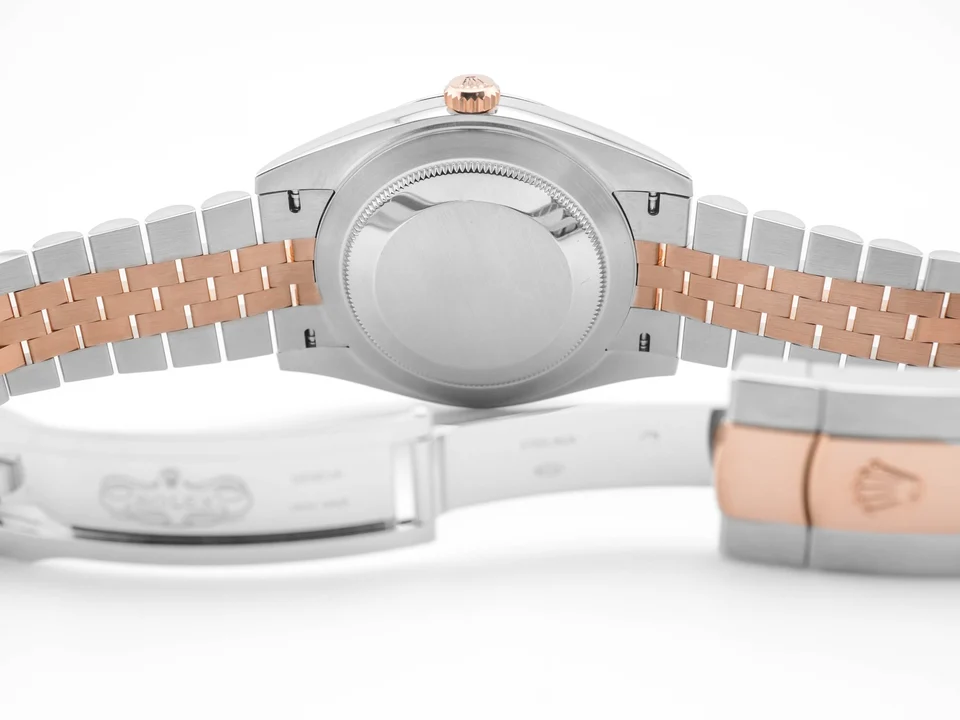 The Rolex Datejust Steel and Rose Gold with a Silver Fluted Motif Dial 126331 combines timeless elegance with classic Rolex luxury. Its Oystersteel and 18k Everose gold construction creates a warm and sophisticated appearance. As a result, this Rolex Datejust remains a distinctive choice for collectors and enthusiasts. The 41mm Oystersteel case offers balanced proportions with a strong presence on the wrist. Its fluted 18k Everose gold bezel adds texture and a distinctive Rolex touch. Meanwhile, the Jubilee bracelet provides a comfortable fit with its elegant five-link design. The silver fluted motif dial creates a refined and distinctive appearance. Its intricate pattern adds depth while complementing the warm Everose gold details. A date window sits at 3 o’clock beneath the signature Cyclops lens for easy reading. The Rolex 126331 is powered by the automatic Caliber 3235 movement. It delivers precise timekeeping and reliable date performance for everyday wear. Overall, the Rolex Datejust 126331 captures the timeless appeal of the Datejust collection. Its Oystersteel case, Everose gold fluted bezel, silver motif dial, and Jubilee bracelet create an elegant combination. Therefore, it makes a prestigious addition to any fine Rolex collection.
