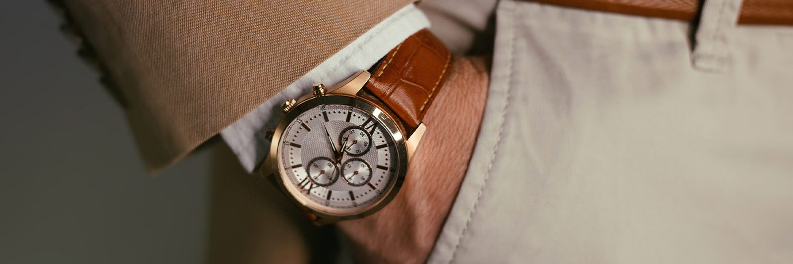 man wearing a vintage watch with brown leather strap.