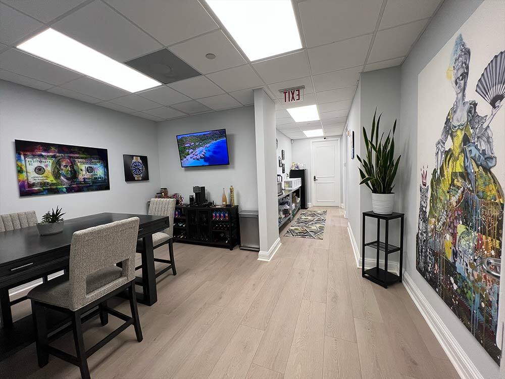 Client lounge and meeting area at WPB Watch Co. A comfortable, art-filled space where customers can relax while discussing watch sales and purchases.