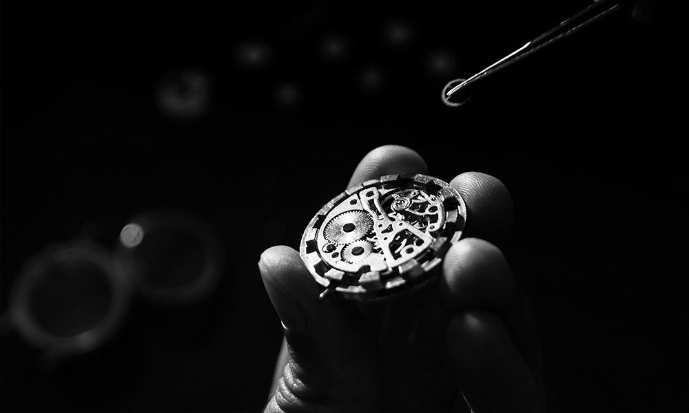 Expert watch technician reassembling a luxury watch during watch overhaul service